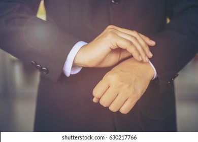 Elegant Businessman Dressing Up For Conference.Close Up Image Of Male Hands. Handsome Man Dressed In Modern Black Formal Suit, White Shirt And Tie Getting Ready For Marketing Meeting.