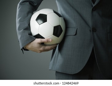 Elegant Businessman Holding A Soccer Ball, Close Up