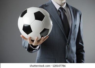 Elegant Businessman Holding A Soccer Ball, Close Up