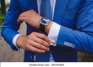 Elegant businessman, male hands corrected cufflinks - Powered by Shutterstock