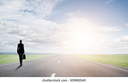 Elegant Businesswoman On Road Standing With Back And Looking Ahead