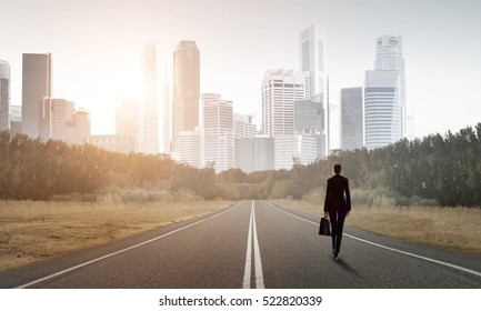 Elegant Businesswoman On Road Standing With Back And Looking Ahead