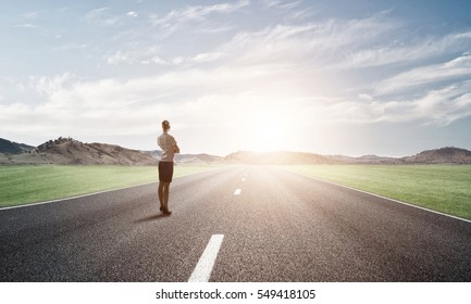 Elegant Businesswoman On Road Standing With Back And Looking Ahead