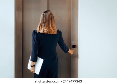 
Elegant Businesswoman Waiting for the Elevator in Office Building. Chic trendy professional lady in anticipation calling for the lift 
 - Powered by Shutterstock