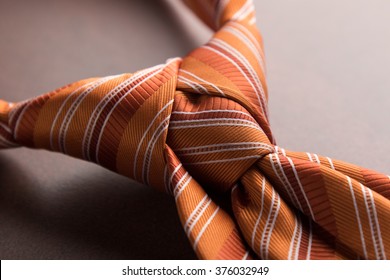 Elegant Casual Orange Neck Tie Knot On Table