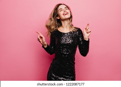 Elegant Caucasian Girl Dancing With Eyes Closed. Indoor Photo Of Refined Woman In Sparkle Black Dress.