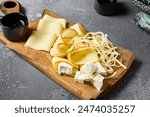 Elegant Cheese Board with Middle Eastern Cheeses - Sulguni, Chechil, Smoked Adyghe Cheese, Imeretian Cheese, and Brined Cheese for Wine Pairing.