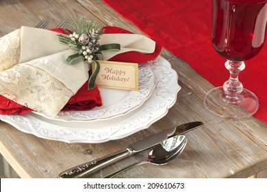 Elegant Christmas Dining Scene On Rustic Wood Table With Happy Holidays Card