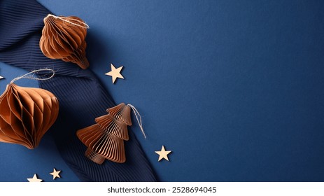 Elegant Christmas handcrafted honeycomb paper ornaments and wooden stars on navy blue background. Hygge, nordic style Xmas decor - Powered by Shutterstock