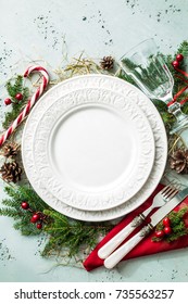 Elegant Christmas Table Setting Design Captured From Above (top View, Flat Lay). Empty White Plate, Glass, Cutlery, Candy Cane And Decorations. Background Layout With Free Text (copy) Space.