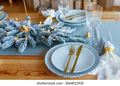 Elegant christmas table setting in gold and blue color for holiday dinner. Christmas or New Years celebration party table setting. - Powered by Shutterstock