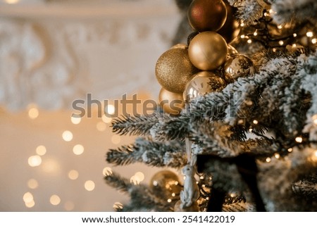 Elegant Christmas Tree Decorated with Golden Ornaments and Soft Lights.