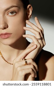 Elegant Close-Up of a Woman Showcasing Gold Jewelry with Stylish Rings and Minimalistic Necklace, Perfect for Fashion and Beauty Concepts