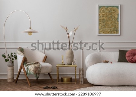Elegant composition of living room interior with mock up poster frame, white sofa, beige armchair, stylish lamp, vase with flowers, plants and personal accessories. Home decor. Template. 