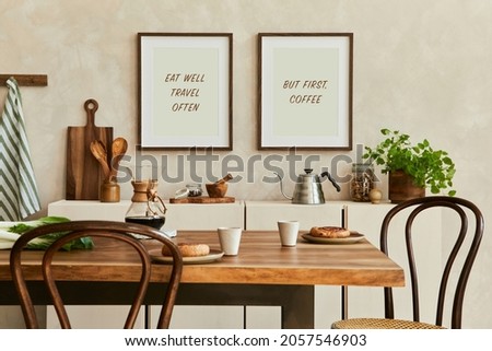 Elegant composition of stylish dining room intrerior with mock up poster frames, beige sideboard, family dining table, plants and vintage personal accessories. Copy space. Template. Autumn vibes.