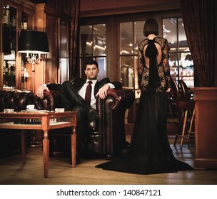 Elegant Couple In Formal Dress In Luxury Cabinet