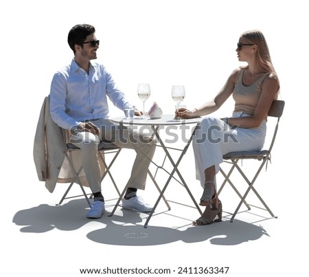 Elegant couple sitting in a restaurant outside in summer and drinking wine isolated on white background