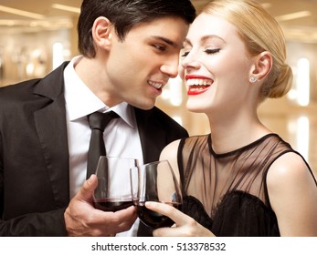 Elegant Couple Talking At Party And Drinking Wine