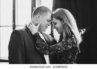 Elegant couple touching face to face, with closed eyes.
