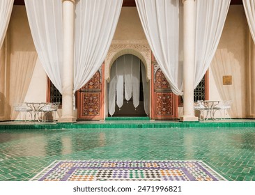 Elegant courtyard at Le Jardin Secret in Marrakech, Morocco with green mosaic tiles, white curtains, Moroccan design, traditional architecture, and serene outdoor decor, luxury cultural travel - Powered by Shutterstock