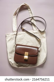 Elegant Cross Body Leather Bag And Textile Linen Shopper For Shopping On A Light Background, Top View   