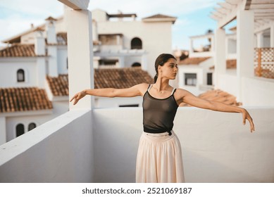 An Elegant Dancer Gracefully Posing on a Rooftop with a Beautiful Scenic Background - Powered by Shutterstock