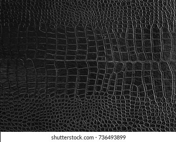 Elegant dark crocodile leather texture background.