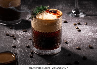 Elegant dark-themed setup featuring a marble table with an espresso, a glass of carajillo garnished with rosemary and dried grapefruit, and a coupe glass with an espresso martini, surrounded by coffee