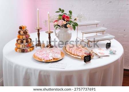 Elegant dessert table setup with macarons flowers and sweets