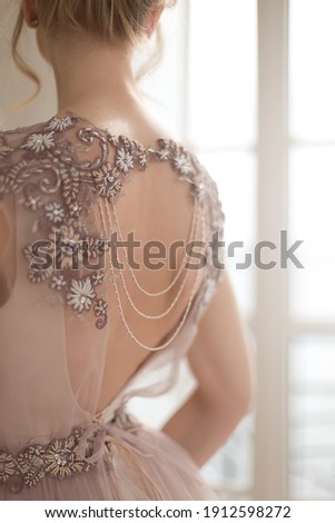Elegant details of the vintage bride look. Exquisite embroidery with beads on the shoulders.