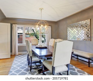 Elegant Dining Room Interior With Wooden Table And Ivory Suede Chairs