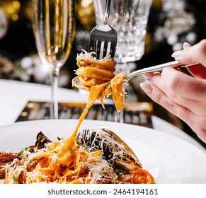 Elegant dining setting with a plate of seafood pasta and a glass of sparkling champagne - Powered by Shutterstock