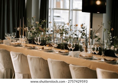 Elegant dining setup features flowers and candles at a modern venue