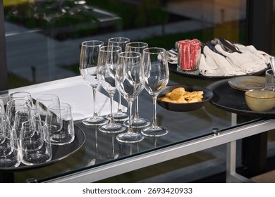 An Elegant Dining Setup Featuring Exquisite Glassware Alongside Delicious Snacks for Enjoyment