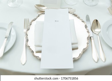 Elegant Dining Table Setting With Classic Silverware And Blank Menu And Seating Name Card