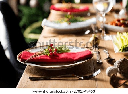 Elegant dining table setting with red napkins, festive decor, and cutlery. A sophisticated, inviting atmosphere perfect for celebrations and gatherings. Christmas food image.