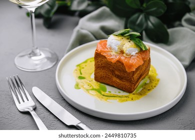 Elegant dish of smoked salmon on brioche with poached egg and basil, ready for a fine dining experience - Powered by Shutterstock