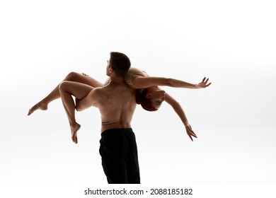 Elegant European Dance Couple Dancing Classical Ballet Dance. Choreography Concept. Woman Wearing Leotard. Man Holding His Female Partner In Arms. Isolated On White Background In Studio. Copy Space