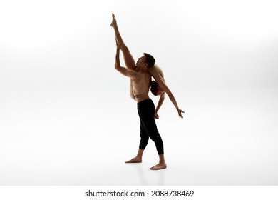 Elegant European Dance Couple Dancing Classical Ballet Dance. Choreography Concept. Woman Wearing Leotard. Man Holding His Female Partner In Arms. People On White Background In Studio. Copy Space