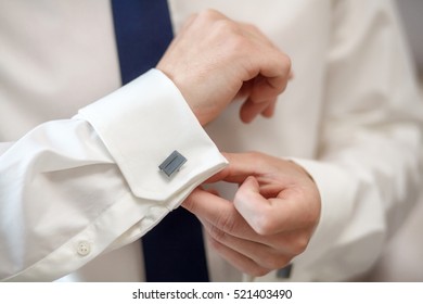 Elegant fashion man fixing his cufflinks, closeup