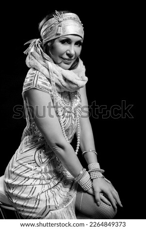 Elegant fashion woman dressed in retro art deco 20s style.
