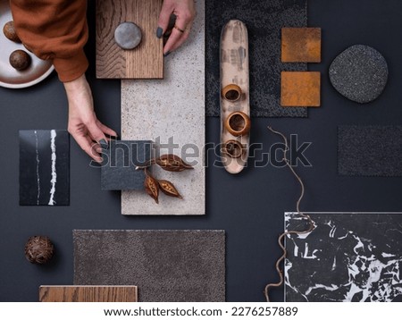 Elegant  flat lay composition in grey and black color palette with textile and paint samples, lamella panels and tiles. Architect and interior designer moodboard. Top view. Copy space. 