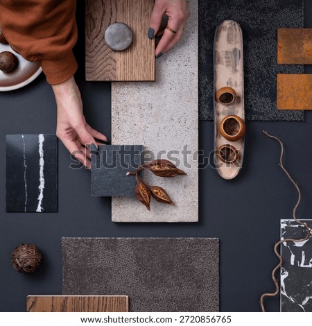 Elegant  flat lay composition in grey and black color palette with textile and paint samples, lamella panels and tiles. Architect and interior designer moodboard. Top view. Copy space. 