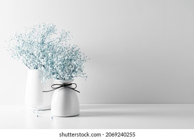 Elegant Floral Soft White Composition, White Flowers. Beautiful White Gypsophila Flower In Vase On White Wall Background.