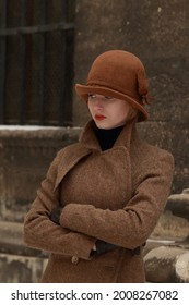 Elegant Girl Model Retro Style Portrait.Young Woman retro style 20s on the street of the old city.Vintage Styled Old Fashioned Makeup.Retro Woman Portrait. Vintage Style Girl Wearing Old fashioned Hat