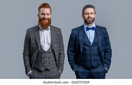elegant glad men in formal formalwear suit. tuxedo men in formalwear isolated on grey background.
