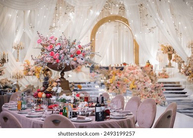 Elegant gold candelabras with lit candles and floral arrangements on a decorative table - Powered by Shutterstock