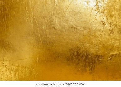 Elegant gold foil texture with distressed finish for luxury design. Abstract grunge metallic surface with scratches and smudges. Versatile golden backdrop for creative projects in fashion