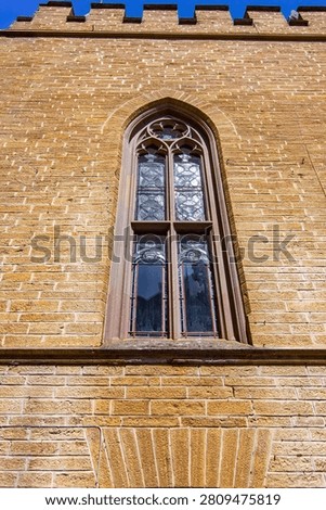 Elegant Gothic arched window set within the sandstone walls of Hohenzollern Castle, highlighting medieval craftsmanship and historic architectural beauty in Germany.