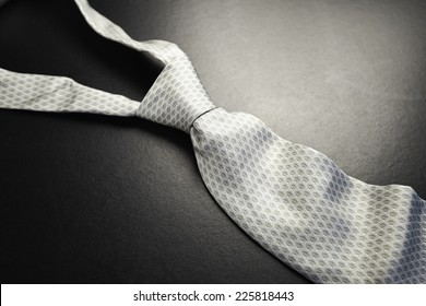 Elegant gray tie on a black background in the style fifty shades of gray - SOFT FOCUS